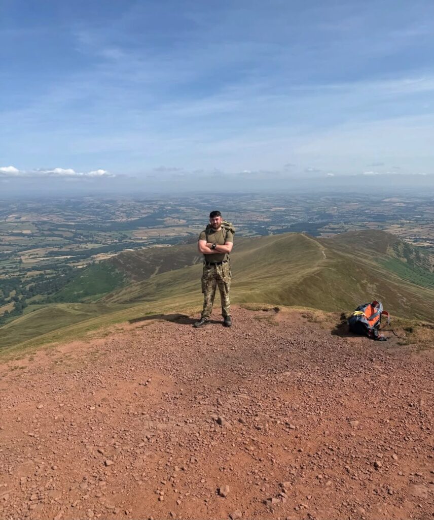 Joseph standing on a hilltop overlooking the countryside